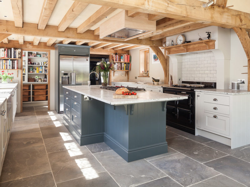 light filled kitchen extension with beams and tiled floor