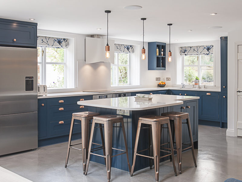 blue kitchen with island and industrial barstools