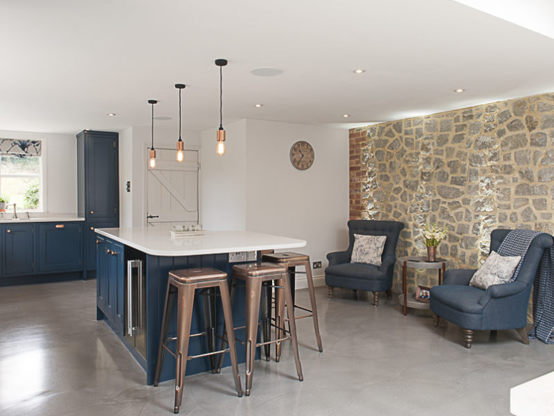 modern blue kitchen with island and living area