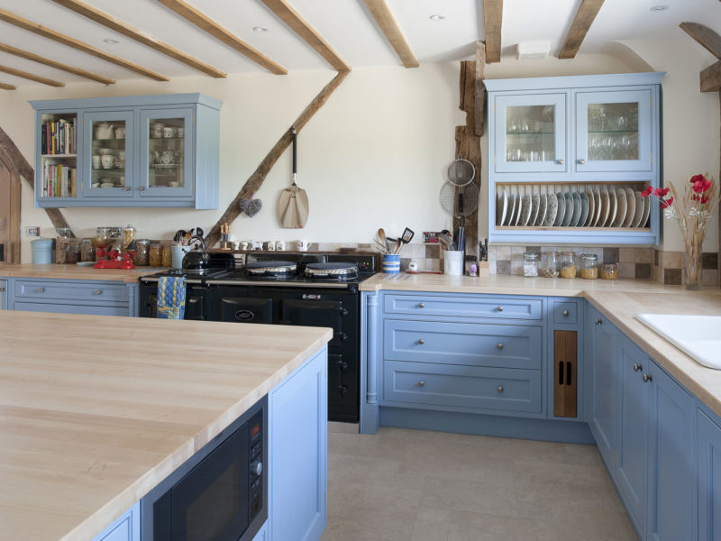 light blue kitchen with beams and island