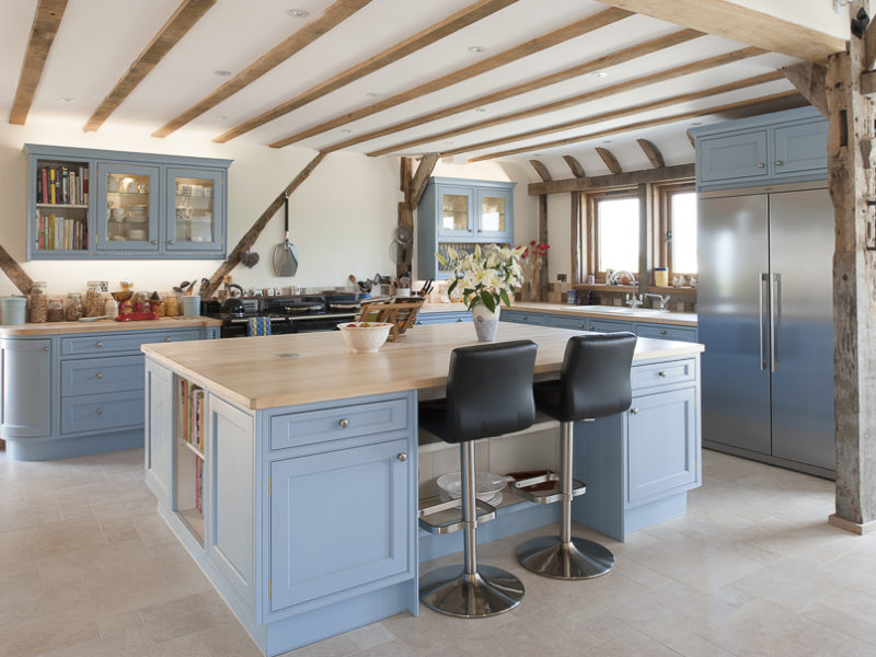 light blue kitchen with wood accents and tiled floor