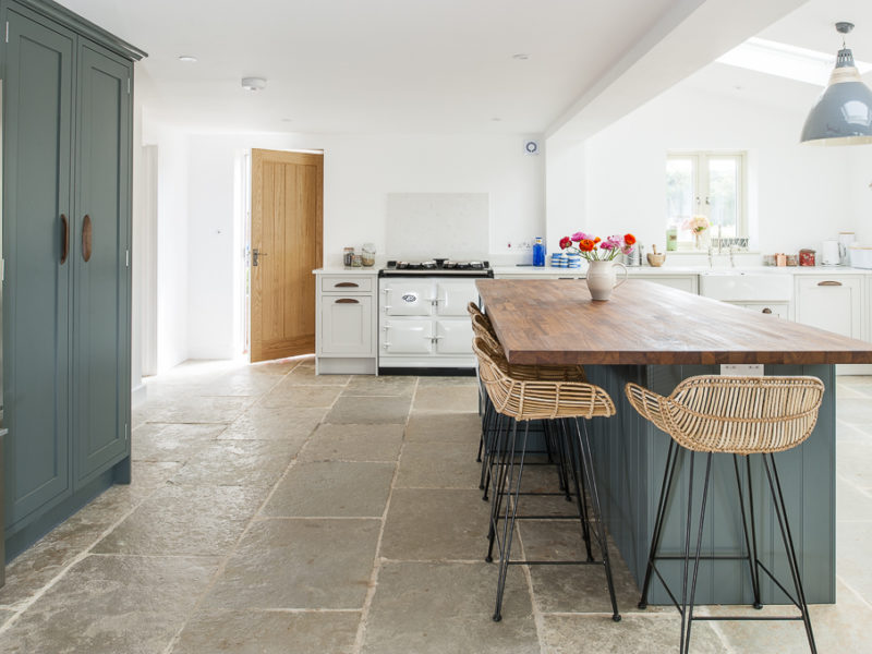 open kitchen with stone tiled floor and breakfast bar