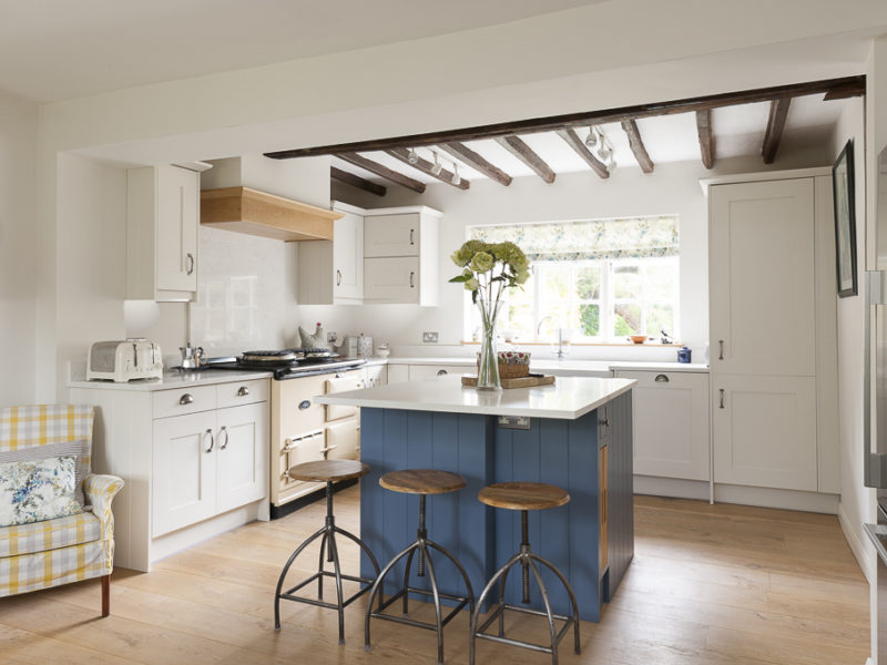 cottage kitchen with beams and blue island