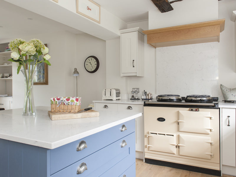 kitchen with blue island and cream range cooker