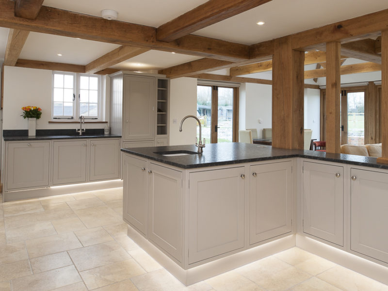grey kitchen with beams and tiled floor