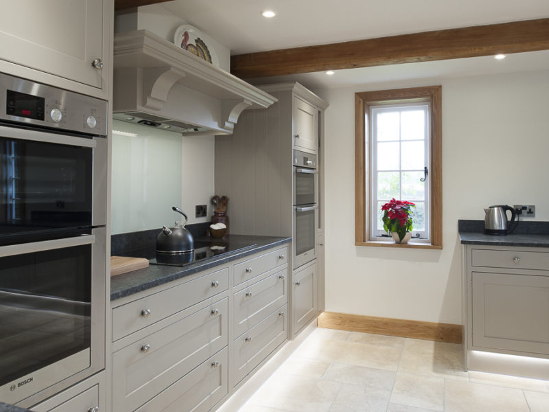 classic grey kitchen with tiled floor and window