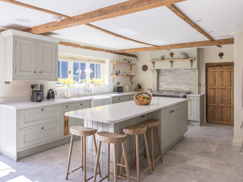 charming farmhouse kitchen with beams and island