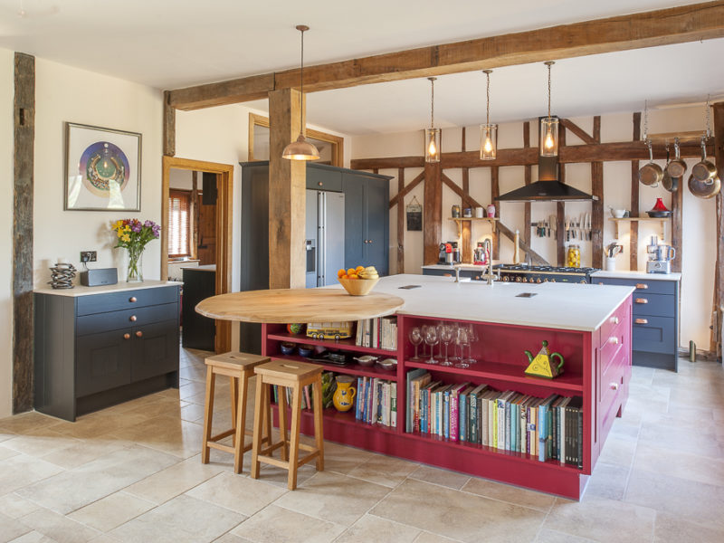 red kitchen island with pendant lights and breakfast bar