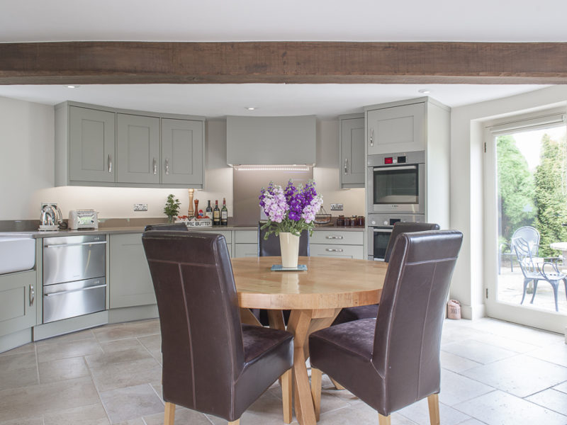 grey kitchen with beams and dining area