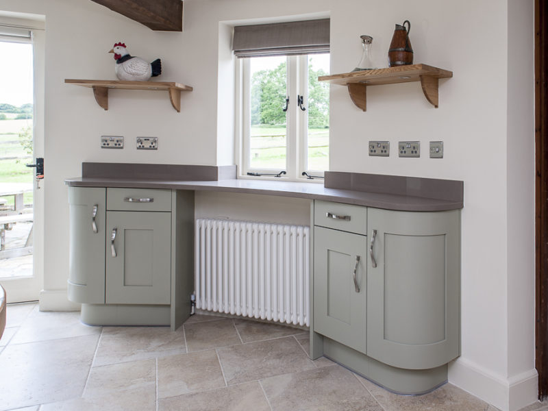 grey round kitchen with wood shelving