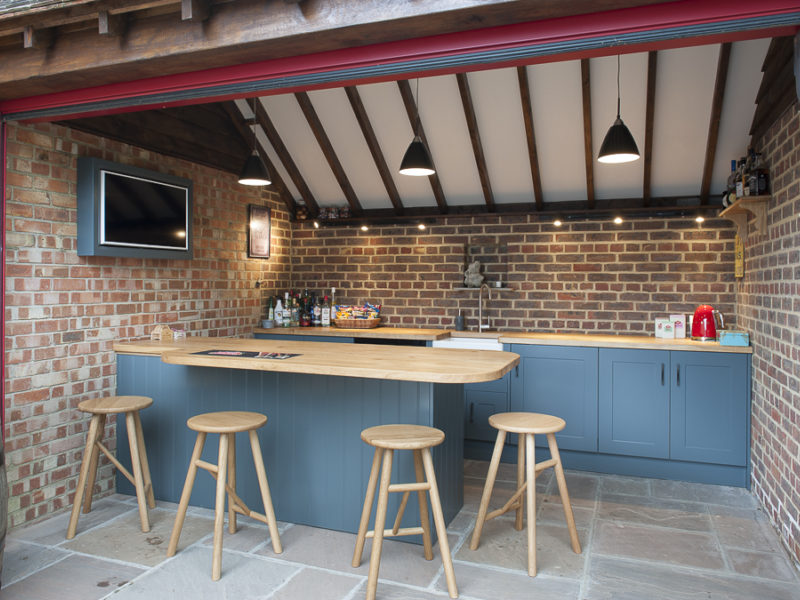 blue outside bar with beams and barstools