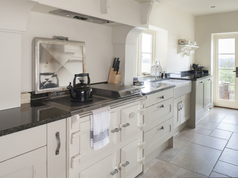 galley kitchen with range cooker and tiled floor