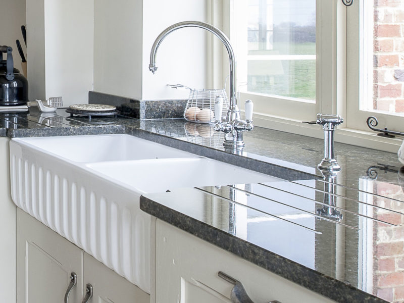 galley kitchen with swan neck tap and belfast sink