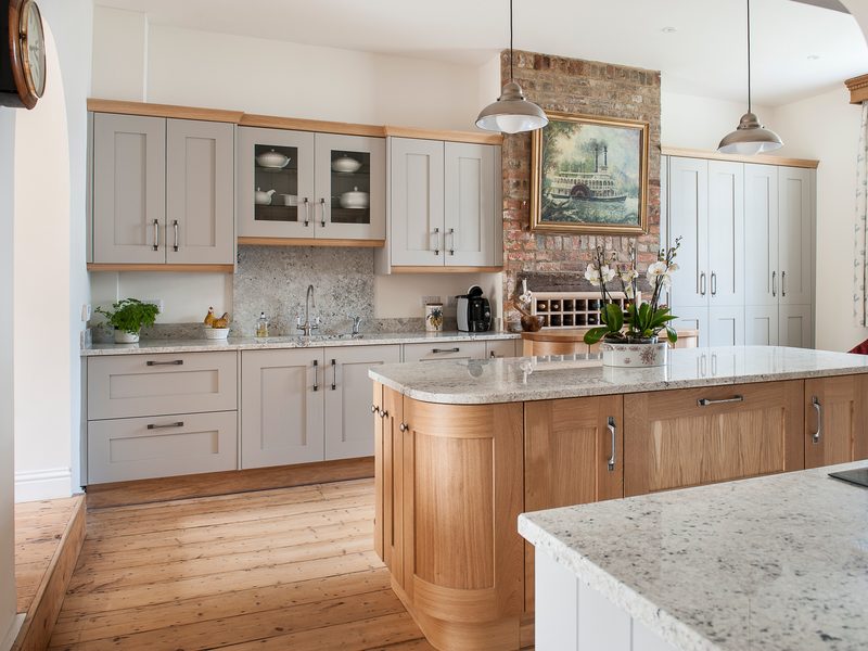 grey kitchen with wood floor and island