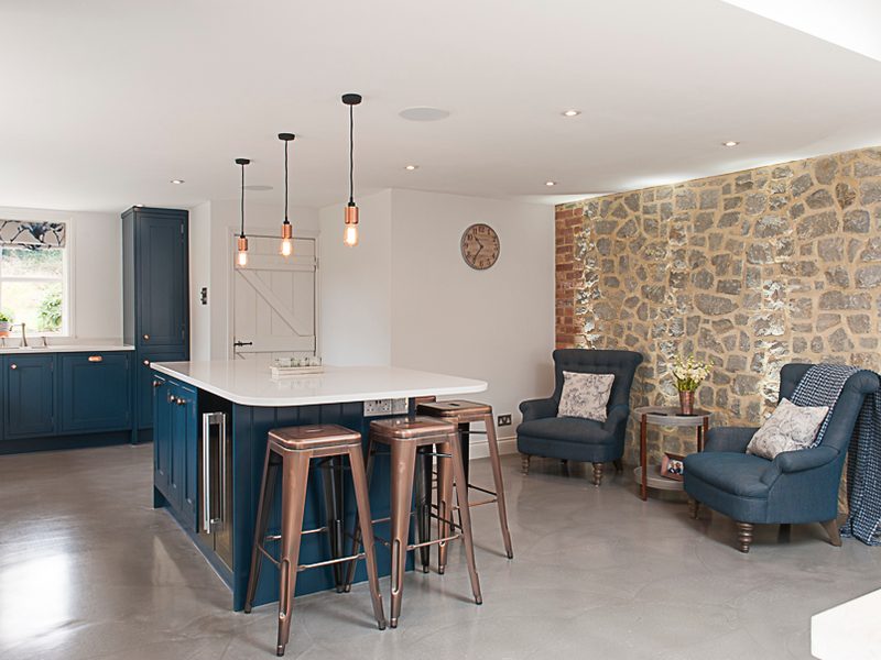 modern blue kitchen with island and living area