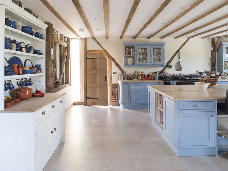 light blue kitchen with shelving unit and beams