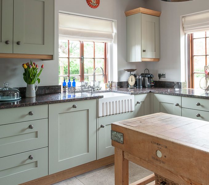 kitchen with butchers block and pendant lamps