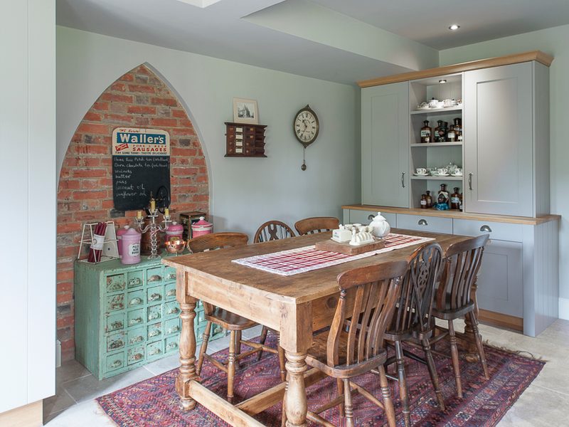 dinig are with wood table and industrial freestanding storage