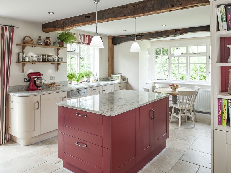 country cottage kitchen with red island and tiled floors
