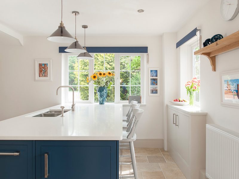 light and airy kitchen with blue island