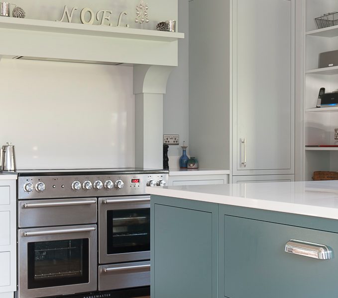 modern country kitchen with blue island and range cooker