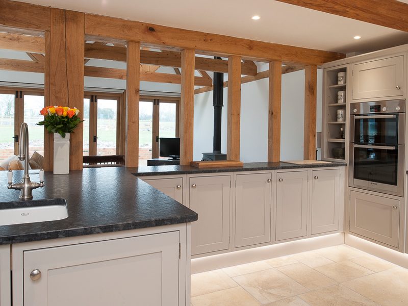 classic grey kitchen with dark worktops and beams