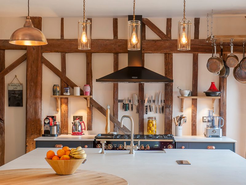 kitchen with oven hood and pendant lamps