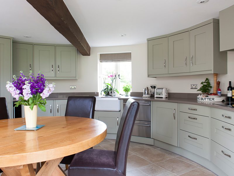 cottage kitchen with beams and wood dining table