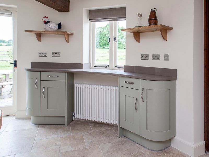 grey round kitchen with wood shelving