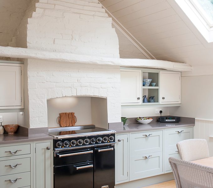 light and airy kitchen with wood floors and range cooker