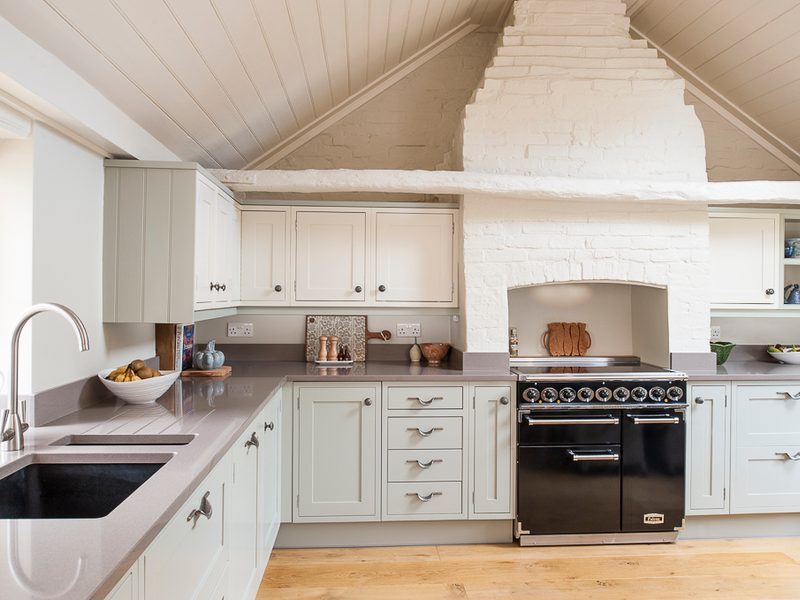 green kitchen with feature brick chimney