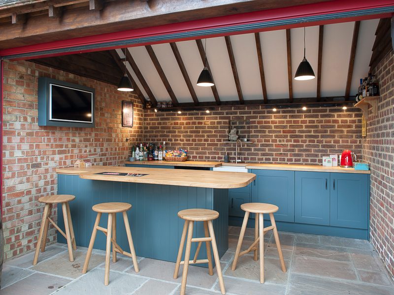 blue outside bar with beams and barstools