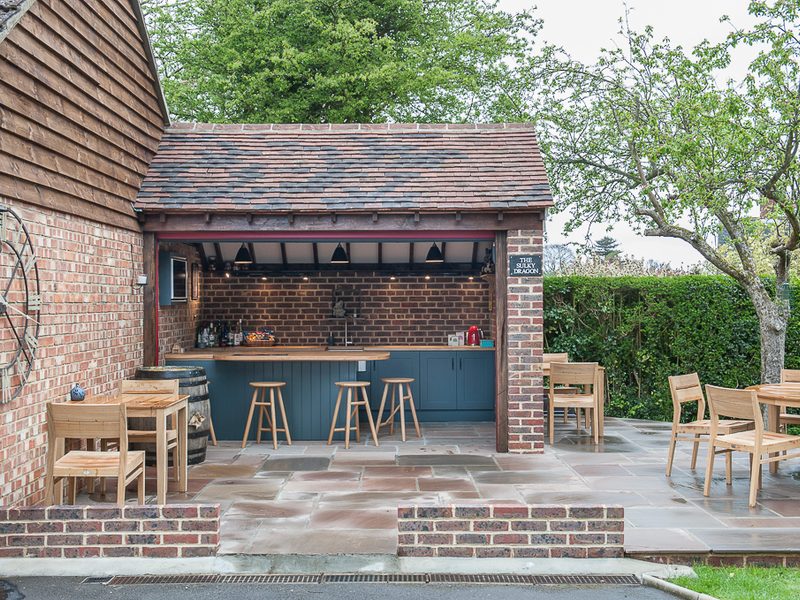 bespoke outside bar with beams and barstools