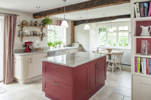 country cottage kitchen with red island and tiled floors
