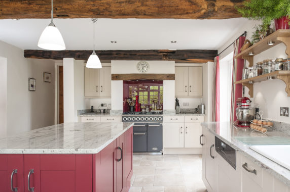 country cottage kitchen with red island and pendant lamps
