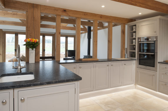 classic grey kitchen with dark worktops and beams