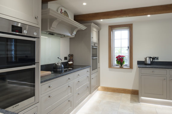 classic grey kitchen with tiled floor and window