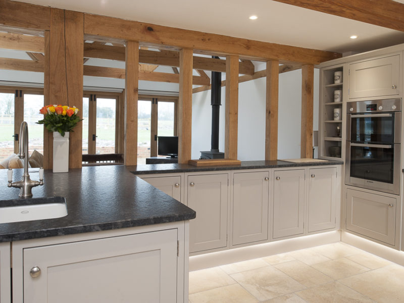 classic grey kitchen with dark worktops and beams