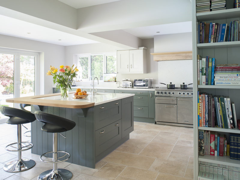 light filled kitchen with shelving and barstools